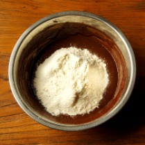 Sifted flour in chocolate mixture